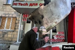 FILE - A man reacts at a residential area after a shelling with cluster ammunition, as Russia's attack on Ukraine continues, in Kharkiv, Ukraine, May 23, 2022.