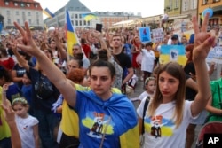 People take part in a rally marking Ukraine's Independence Day and the six-month anniversary of the Russian invasion of Ukraine in Warsaw, Poland, Aug. 24, 2022.
