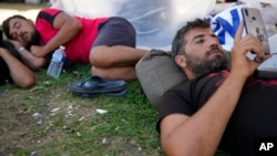 Hundreds of migrants seek shelter outside an overcrowded asylum seekers center in Ter Apel, northern Netherlands, Aug. 25, 2022.