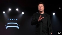 FILE - Tesla CEO Elon Musk speaks before unveiling the Model Y at the company's design studio on March 14, 2019, in Hawthorne, California.