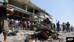 People gather at the sight of a reported regime forces bombing at a busy market in the opposition-held city of Al-Bab, on the border with Turkey in Syria's northern Aleppo province, on August 19, 2022.