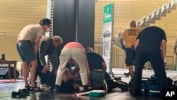 Author Salman Rushdie is tended to after he was attacked during a lecture, Aug. 12, 2022, at the Chautauqua Institution in Chautauqua, N.Y., about 120 km (75 miles ) south of Buffalo.