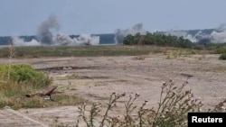 Munitions explode amid an ongoing Ukrainian military counter-offensive against Russian occupying forces, said to be near Andriivka, Kherson region, Ukraine sometime in August 2022 in this still image taken from social media video. (Maverick via Reuters)