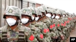In this handout photo taken from video released by Russian Defense Ministry Press Service on Aug. 29, 2022, Chinese soldiers participate in war games drills, in Grodekovo, Primorsky Krai, Russia. 