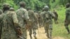 FILE - Ugandan troops are seen on a road in the Beni district of the Democratic Republic of Congo, Dec. 8, 2021. More Ugandan troops will be sent to DRC at the end of November 2022 to help fight rebels. 