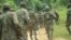 FILE - Ugandan troops are seen on a road in the Beni district of the Democratic Republic of Congo, Dec. 8, 2021. More Ugandan troops will be sent to DRC at the end of November 2022 to help fight rebels. 