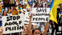 People attend a march to protest against the Russian invasion of Ukraine, in Melbourne, Australia, on Feb. 27, 2022.
