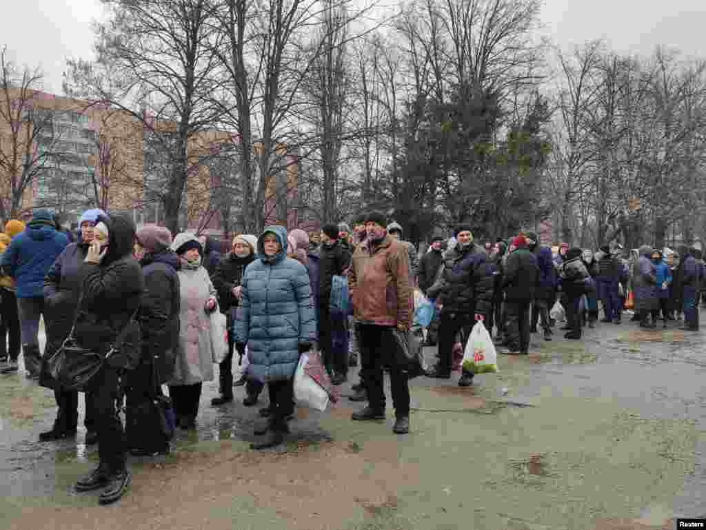 Local residents queue to receive food at a hospital in Kharkiv as Russia's invasion of Ukraine continues, March 2, 2022.