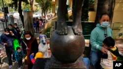 Children accompanied by their parents line up to receive China's Sinovac COVID-19 coronavirus vaccine at a community vaccination center in Hong Kong, Feb. 25, 2022. 