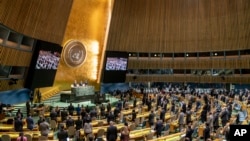 Delegations stand for a moment of silence during an emergency session of the U.N. General Assembly, Feb. 28, 2022, at United Nations Headquarters in New York.