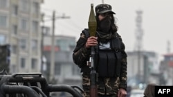 FILE - A Taliban fighter stands with a rocket-propelled grenade on a vehicle in Kabul, Jan. 21, 2022. 