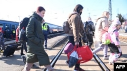 Ukrainian refugees arrive from their homeland at Zahonyi railway station close to the Hungarian-Ukrainian border, Feb. 27, 2022.