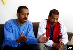 FILE - Alexanda Amon Kotey, left, and El Shafee Elsheikh, who were among four British jihadis who made up a brutal Islamic State cell dubbed "The Beatles," speak in Kobani, Syria, March 30, 2018.