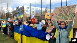 Protesters take part in a demonstration outside a NATO leaders virtual summit at NATO headquarters in Brussels, Feb. 25, 2022.