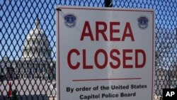 The U.S. Capitol dome is seen through a security fence put in place in preparation for President Joe Biden's State of the Union address on Capitol Hill in Washington, Feb. 27, 2022.