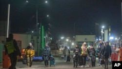 Refugees fleeing conflict in Ukraine arrive at the Medyka border crossing in Poland, Feb. 27, 2022. The U.N. has estimated the conflict could produce as many as 4 million refugees, depending how long the invasion continues. 