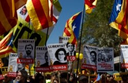 FILE - Demonstrators wave independence flags in Barcelona, Spain, April 15, 2018, during a protest in support of Catalonian politicians who have been jailed on charges of sedition.