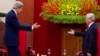 Vietnam's Communist Party General Secretary Nguyen Phu Trong greets U.S. Secretary of State John Kerry (L) in Hanoi, Dec. 16, 2013.