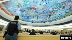 A U.N. security officer stands guard during a special session on the situation in Ukraine of the Human Rights Council at the United Nations in Geneva, Switzerland, March 4, 2022.