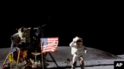 In this April 1972 photo made available by NASA, John Young salutes the U.S. flag at the Descartes landing site on the moon during the first Apollo 16 extravehicular activity. 