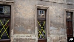 A woman has breakfast inside a cafe in Lviv's downtown, western Ukraine, March 4, 2022.