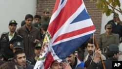 Protesters remove the flag of the British embassy in Tehran, November 29, 2011.
