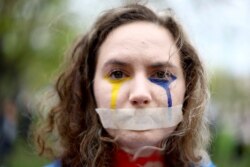 A woman in Berlin takes part in a demonstration, "The real price of Russian gas and oil," to protest against Russia's invasion of Ukraine on April 21, 2022. (Lisi Niesner/Reuters)
