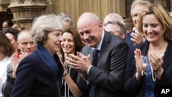 Conservative Party members of Parliament applaud Theresa May, Britain's incoming prime minister, in London, July 11, 2016. 