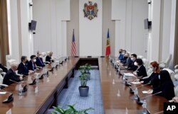 U.S. Secretary of State Antony Blinken, second left, meets with Moldovan Prime Minister Natalia Gavrilita, third right, at the Government House in Chisinau, Moldova, March 6, 2022