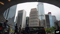 FILE - Participants are seen departing the venue for the Global Financial Leaders' Investment Summit in Hong Kong, Nov. 2, 2022.