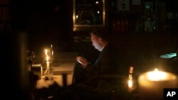 A man sits in a caffe during a blackout in Kyiv, Ukraine, Nov. 4, 2022.