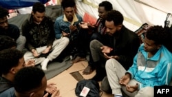 Migrants pray aboard the 'Ocean Viking' rescue ship of European maritime-humanitarian organization 'SOS Mediterranee' in the Gulf of Catania in the Mediterranean Sea in international waters, Nov. 6, 2022.