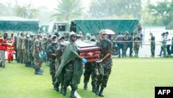 Soldiers carry the casket of a victim, after a passenger plane plunged into Lake Victoria, at the Kaitaba Stadium in Bukoba, Tanzania, Nov 7, 2022.