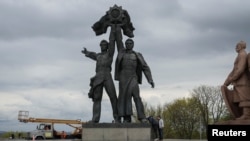 A Soviet monument to a friendship between Ukrainian and Russian nations is seen before its demolition, in central Kyiv, Ukraine April 26, 2022.