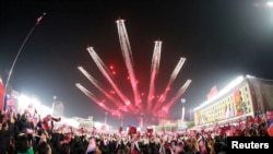 Planes perform an aerial display during a nighttime military parade to mark the 90th anniversary of the founding of the Korean People's Revolutionary Army in Pyongyang, North Korea, in this undated photo released by North Korea's Korean Central News Agenc