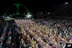 FILE - Members of the Imperatriz Leopoldinense samba school performs during the Carnival parade at the Sambadrome in Rio de Janeiro, Brazil, April 22, 2022.