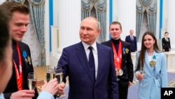 Russian President Vladimir Putin meets with Russian athletes in the Kremlin in Moscow, Russia, April 26, 2022.