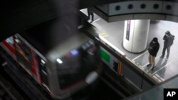 Passengers wait at platform for their trains arrival at Tokyu Railways' Shibuya Station, April 20, 2022, in Tokyo, Japan.