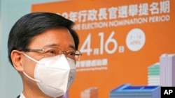 Former Hong Kong Chief Secretary John Lee poses for a photograph before submitting his candidacy for the Election of the Chief Executive, in Hong Kong, April 13, 2022. 