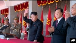 FILE - In an image made from video, North Korean leader Kim Jong Un, center, and Liu Yunshan, China's Communist Party's No. 5 leader, second right, waves during a ceremony to mark the 70th anniversary of the country's ruling party, in Pyongyang, Oct. 10, 