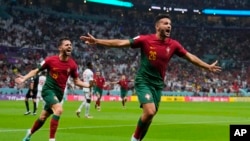 Portugal's Goncalo Ramos, right, celebrates after scoring during the World Cup round of 16 soccer match between Portugal and Switzerland, at the Lusail Stadium in Lusail, Qatar, Dec. 6, 2022. 