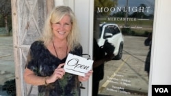 Lisa Ash stands in front of her shop in Mandeville, Louisiana. Like many Americans concerned about the downturn and their shrinking lifelong savings, Ash, 62, says "the economy has affected those of us preparing for retirement in a big way." (Matt Haines/VOA)