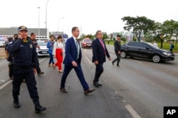 Federal Interventor Ricardo Cappelli, center, inspects military troops as they wait for a protest announced by supporters of former President Jair Bolsonaro, in Brasilia, Brazil, Jan. 11, 2023. The mass demonstration failed to materialize.