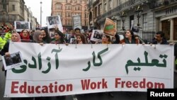 FILE - Protesters take part in a march and rally in support of Afghan women's rights in London, Nov. 27, 2022.