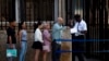 People stand in line outside the U.S. embassy on the day of its reopening for visa and consular services in Havana, Cuba, Jan. 4, 2023.