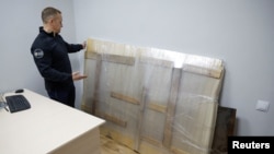 FILE - The recovered work of street artist Banksy, which a group of people tried to steal from a wall of a residential building in the town of Hostomel, is held at a police office in the town of Boiarka, Kyiv region, Ukraine, Dec. 3, 2022. 