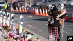 FILE - Visitors hug near the scene of a mass shooting at a gay nightclub in Colorado Springs, Colorado, on Nov. 23, 2022. The U.S. is in “a heightened threat environment” because of lone offenders and small groups, according to the new National Terrorism Advisory System bulletin.
