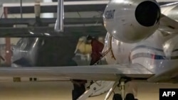 WNBA star Brittney Griner exits a plane in San Antonio, Texas, after she was released from a Russian prison in exchange for an arms dealer.