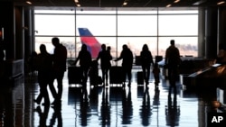 People pass through Salt Lake City International Airport, Jan. 11, 2023, in Salt Lake City. 