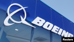 FILE - Signage for Boeing is seen on a trade pavilion, July 19, 2022. 